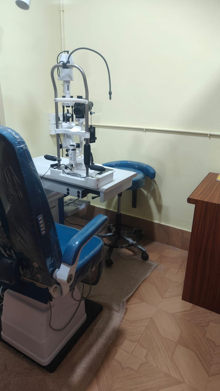 Slit lamp examination bay with patient chair at the clinic